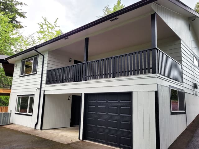 A photo of a house with fresh exterior painting. The house is painted in a modern color scheme.