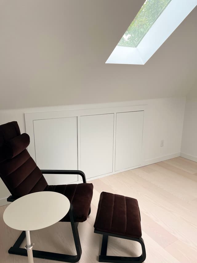 A photo of an attic space with a new skylight installed, bringing natural light into the room.